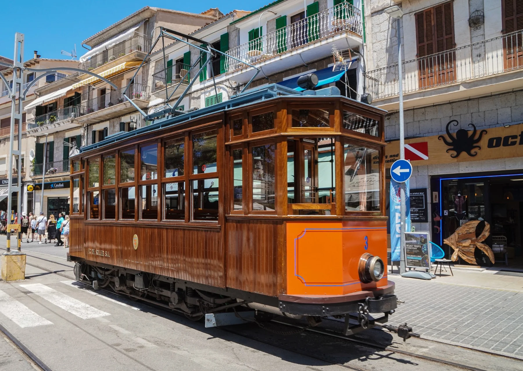 An urban tram passing multistorey buildings